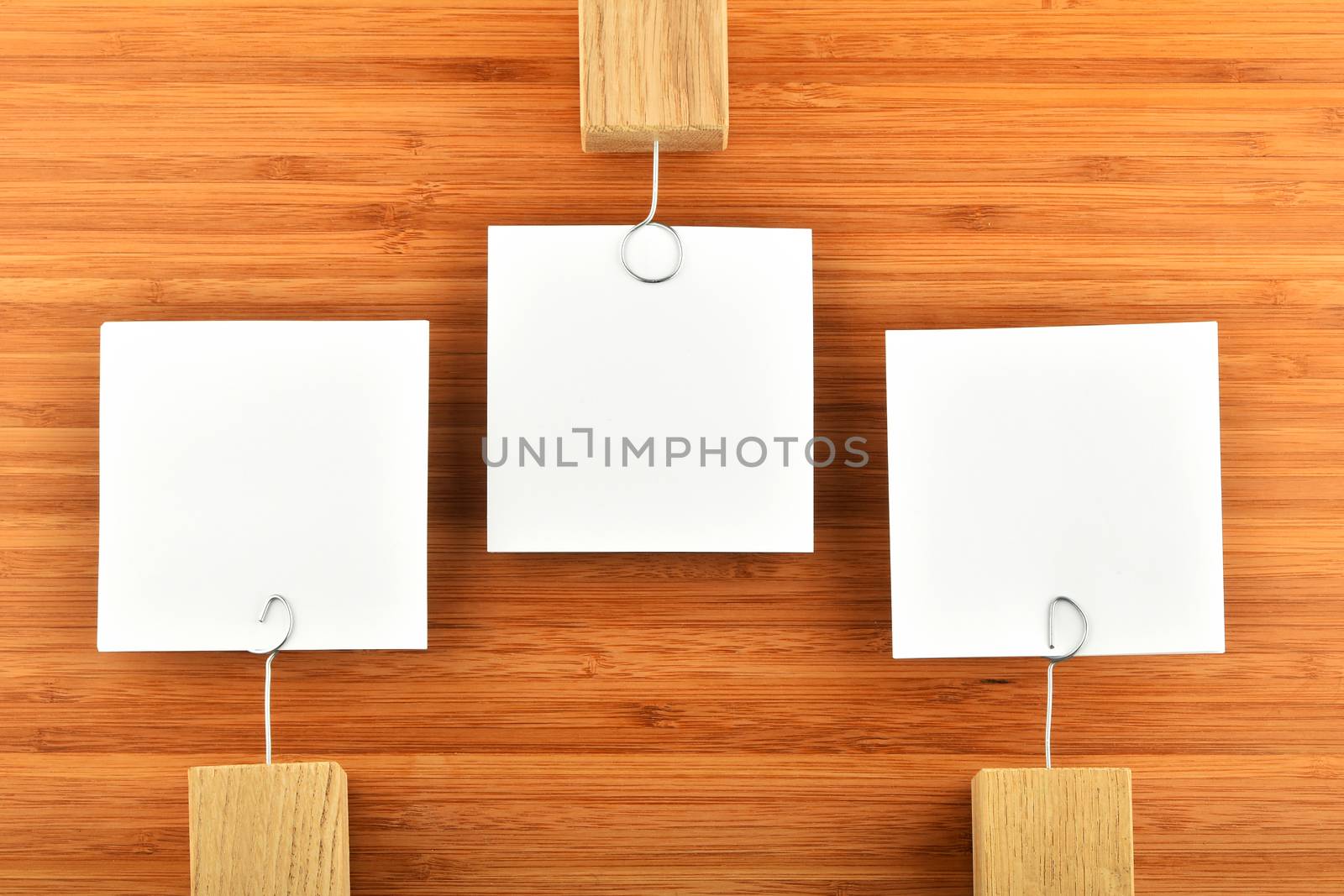 Three paper notesin different directions on wooden background by BreakingTheWalls