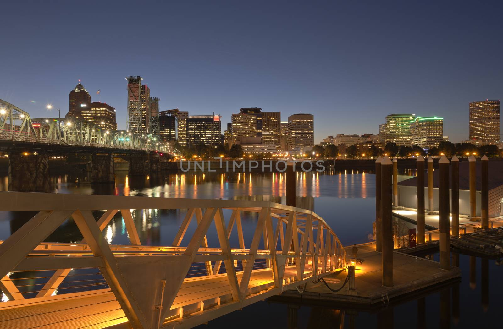 City of Portland Oregon skyline river and pedestrian bridge at twilight.