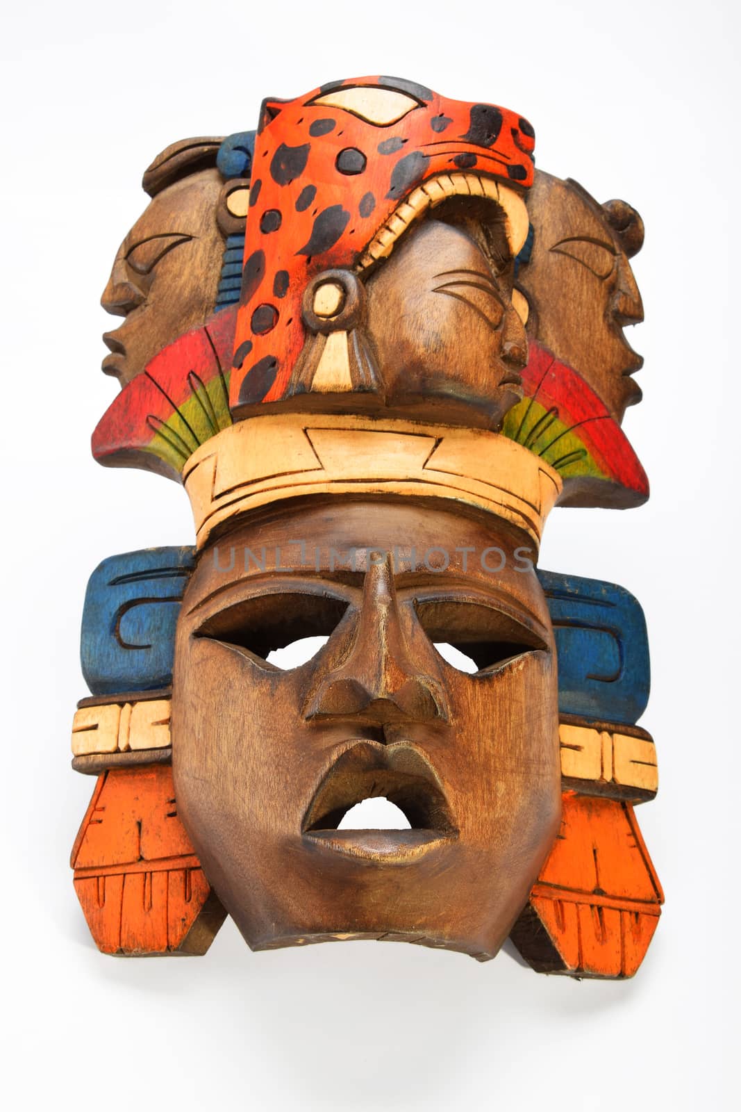 Indian Mayan Aztec wooden painted mask with roaring jaguar and human profiles isolated on white background