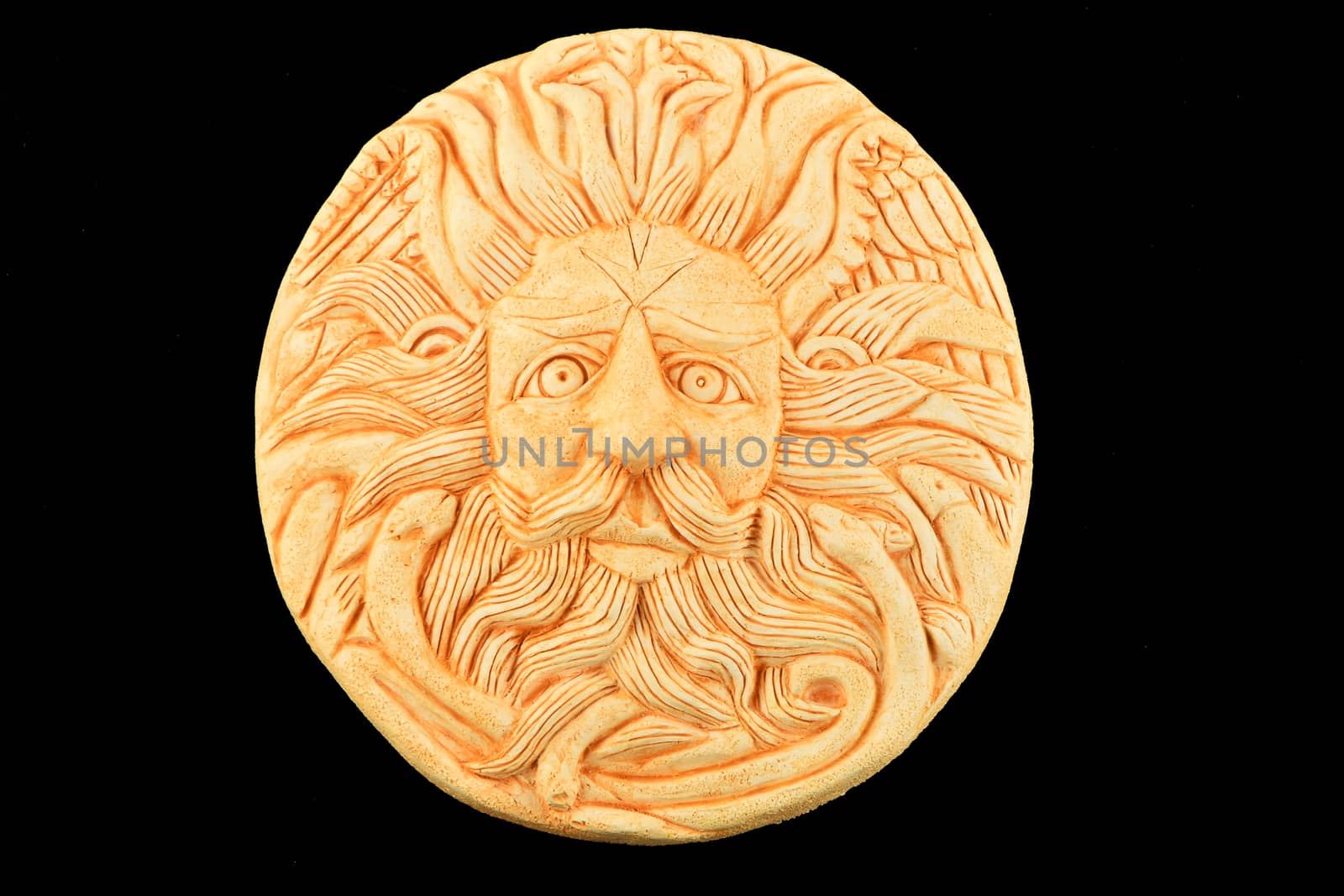 Tourist ceramic souvenir replica of male Gorgon Medusa head in Minerva temple in Roman Bath in England isolated on black