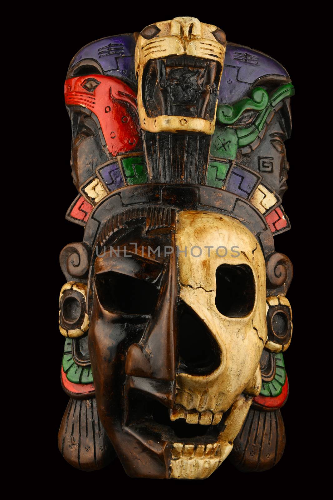 Mexican Mayan Aztec ceramic painted mask with skull isolated on black
