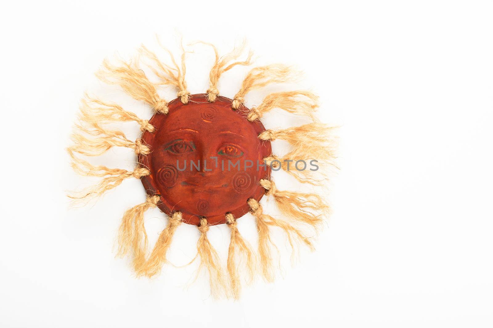 Mexican traditional ceramic happy sun face symbol plate with rays of jute rope isolated on white