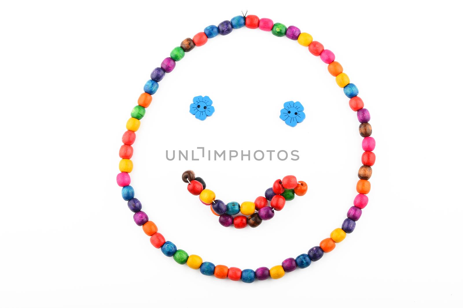 Smile of colorful handmade wooden round beads necklace and bracelet isolated on white