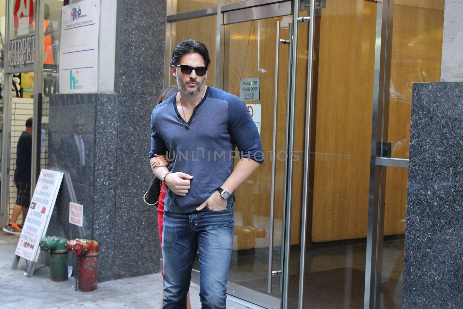USA, New York: TV star Joe Manganiello heads to his car after visiting Ron Ben-Israel Cakes in Midtown Manhattan with superstar fiancee Sofia Vergara (behind) on September 23, 2015. Bakery staff confirmed that the super couple was at the shop; but when asked if the pair had decided to buy their wedding cake from the bakery, one employee revealed that it was all up in the air.