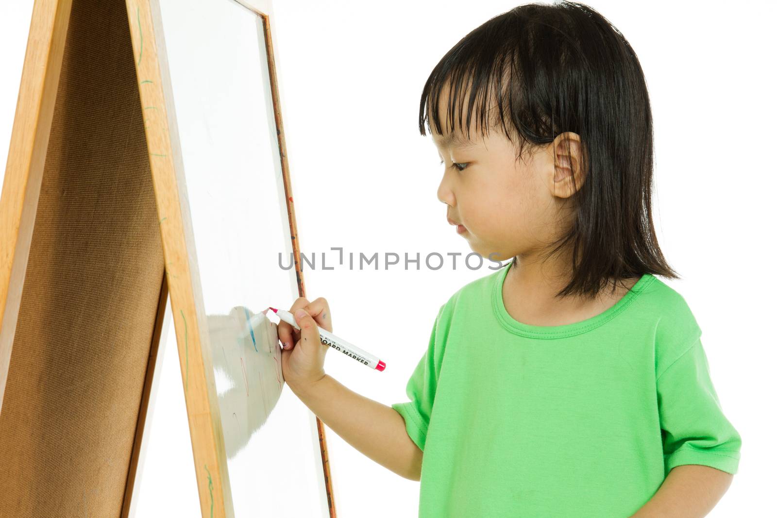 Chinese little girl writing on whiteboard by kiankhoon