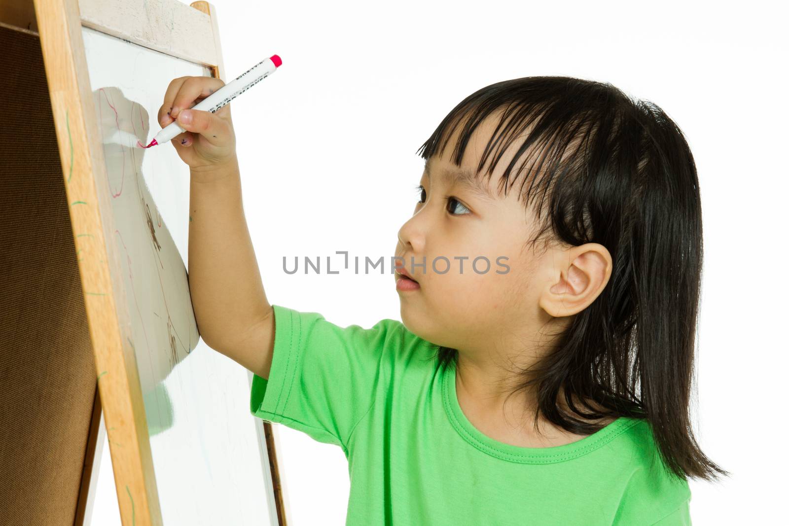 Chinese little girl writing on whiteboard by kiankhoon