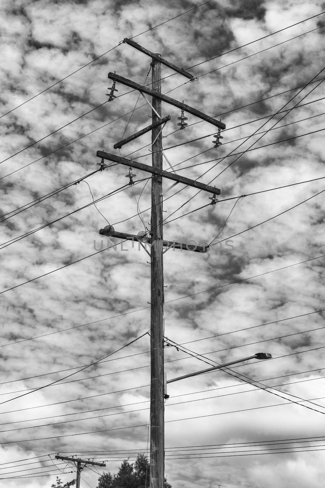 Aged timber power line pole with clouds and sky in the background during the day at Brisbane, Queensland