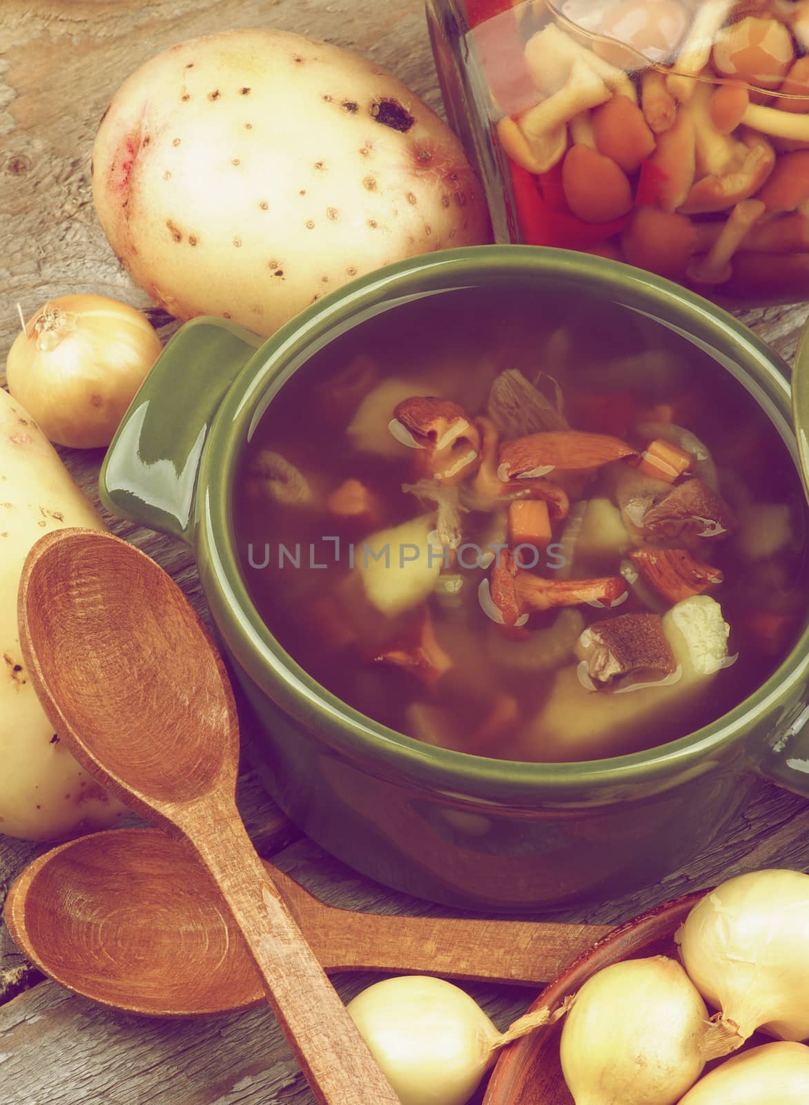 Homemade Vegetarian Soup with Chanterelle Mushrooms  in Green Pot and Raw Ingredients closeup Rustic Wooden background. Retro Styled