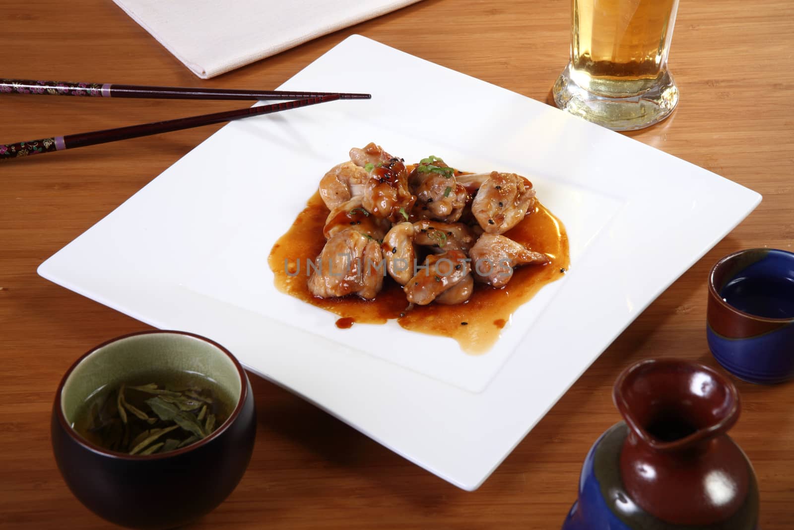 Japanese cuisine chicken with sauce on square plate