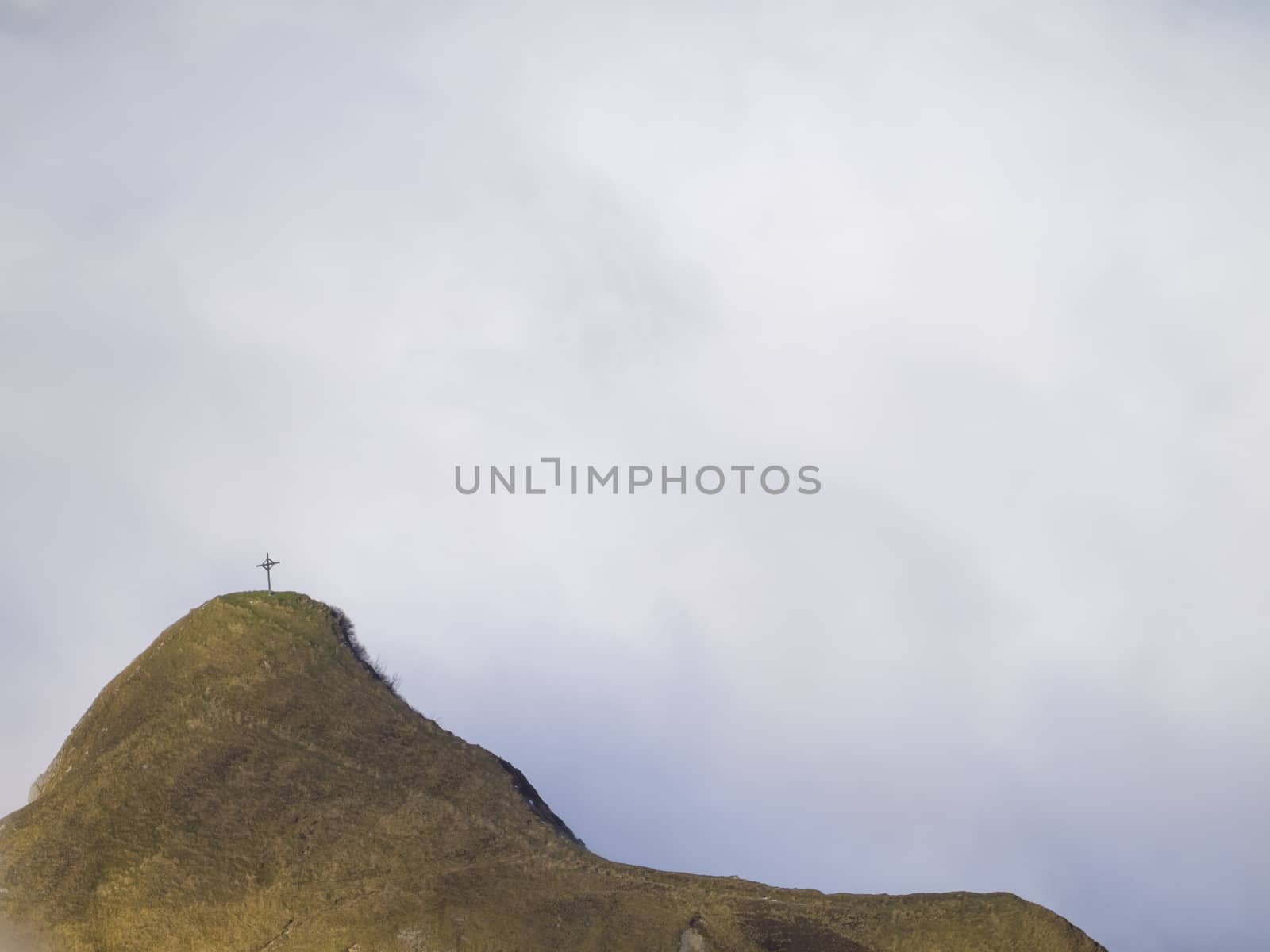 Cross on the summit of Klimsenhorn mountain, view from mount Pilatus, Lucerne, Switzerland.