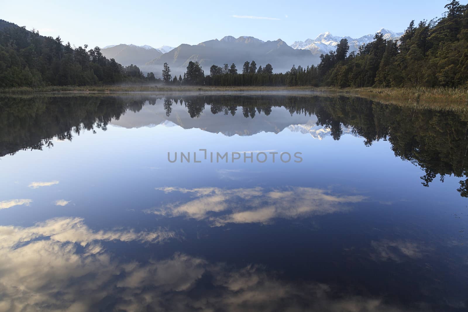 Reflection of Lake Matheson with Mount Cook and Mount Tasman as background, West Coast region, South Island, New Zealand.