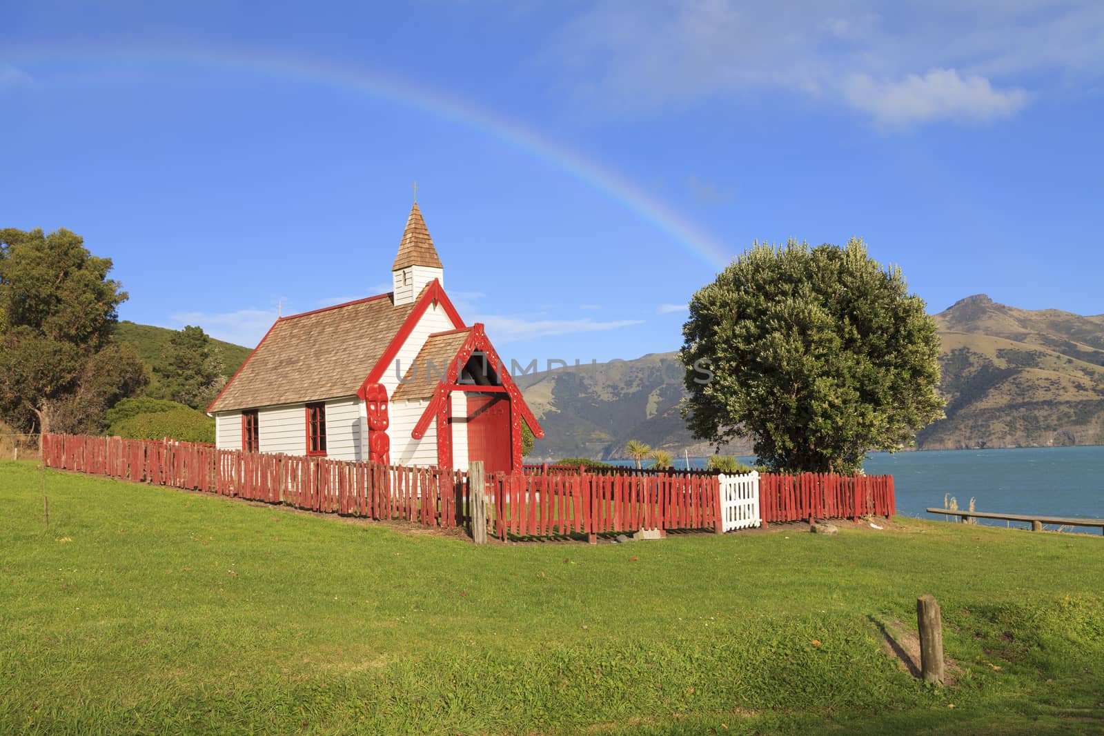 Beautiful ancient Maori church under the rainbow in Akaroa, New Zealand