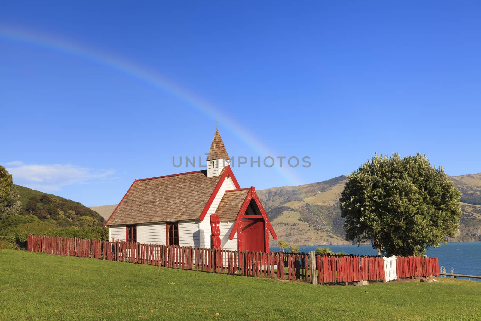 Beautiful ancient Maori church under the rainbow in Akaroa, New Zealand