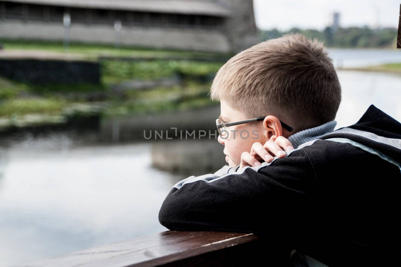 sad boy looking at the river by alexx60
