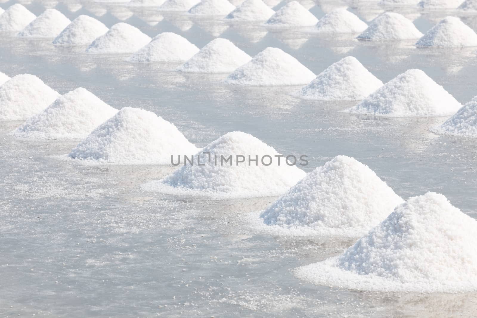Heap of sea salt in salt farm ready for harvest,  Thailand.