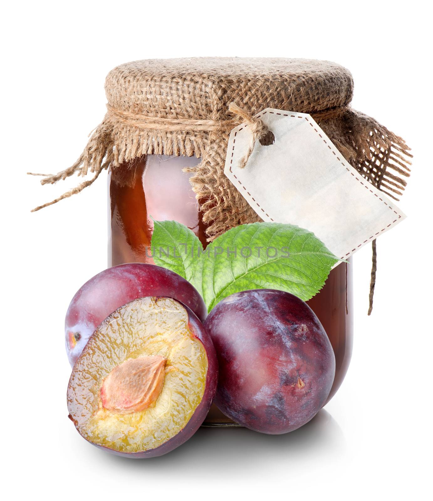 Plums and confiture in a jar isolated on white