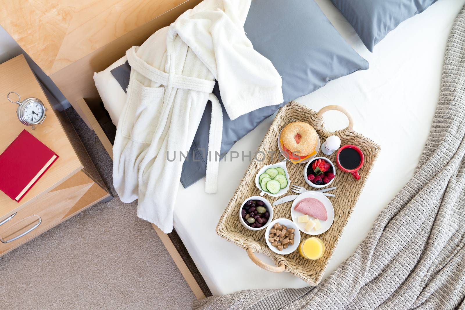 Bathrobe and Breakfast Tray on Unmade Bed by coskun