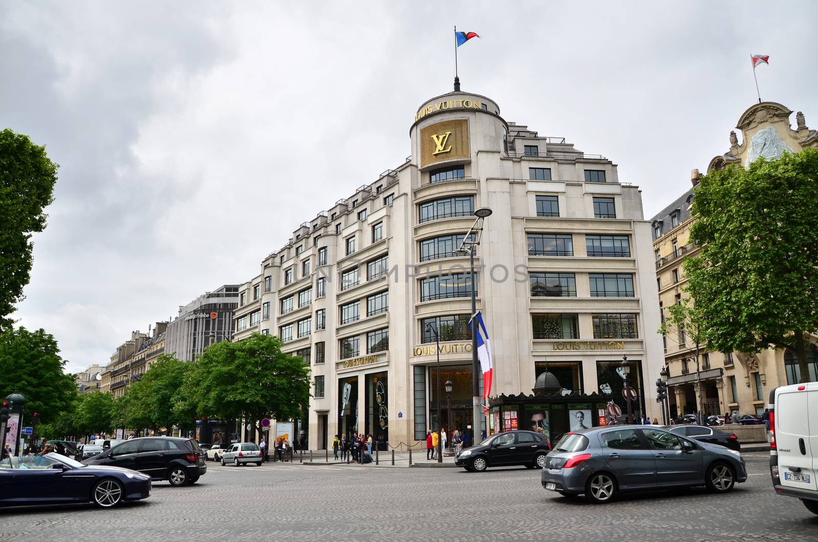 Paris, France - May 14, 2015: Tourists Shopping at Louis Vuitton Store in Paris by siraanamwong