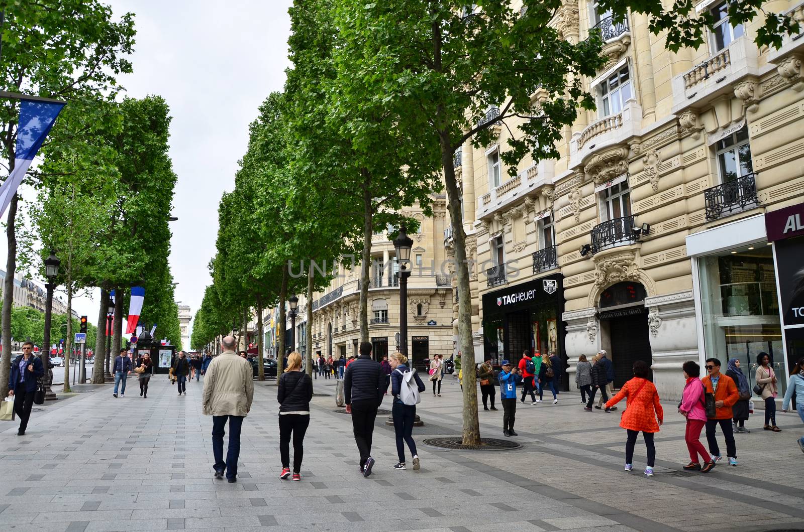 Paris, France - May 14, 2015: Local and tourists on the Avenue des Champs-elysees on May 14, 2015.The Avenue is one of the most famous streets in the world for upscale shopping.