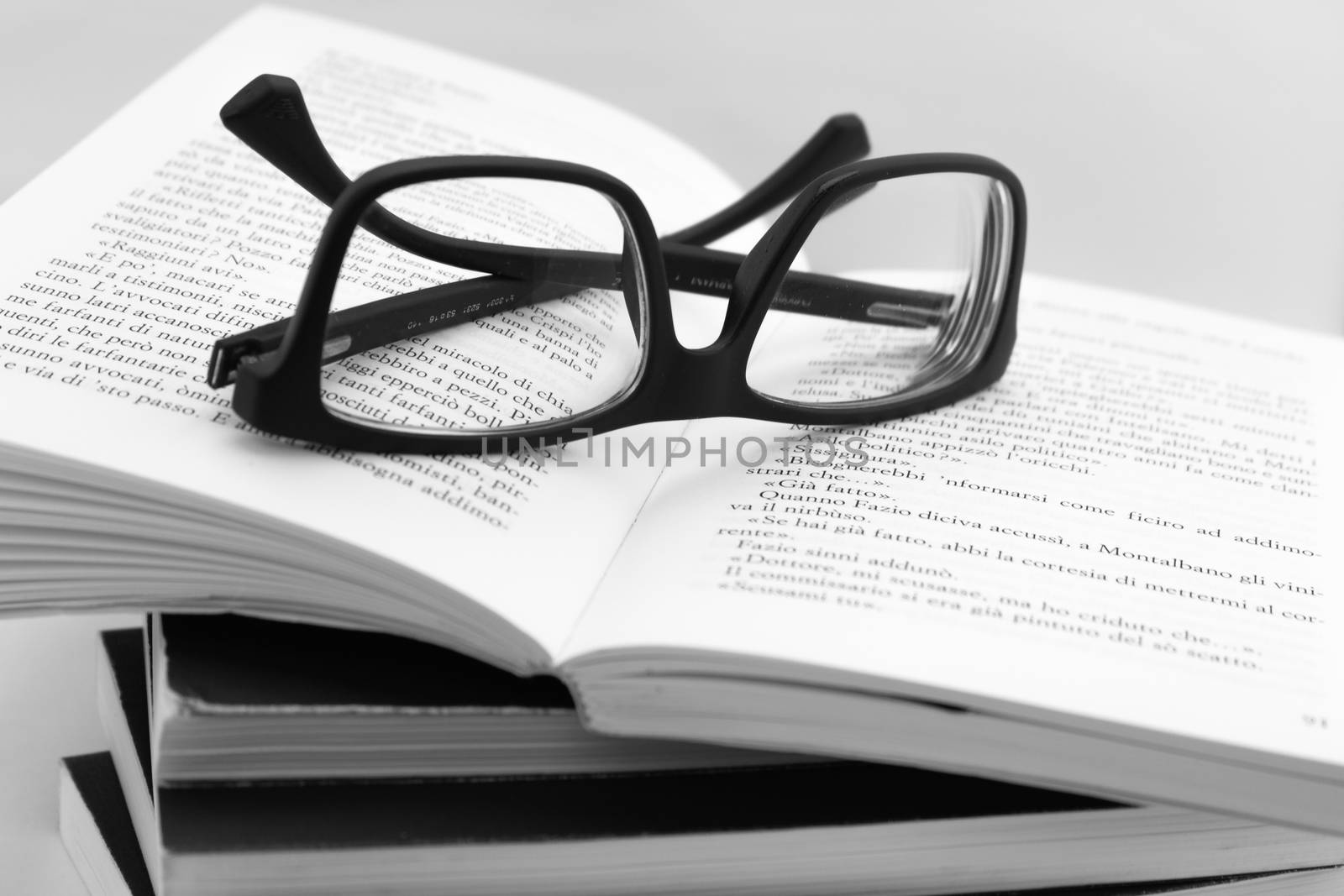 We are going to read books. Books and glasses on white background.