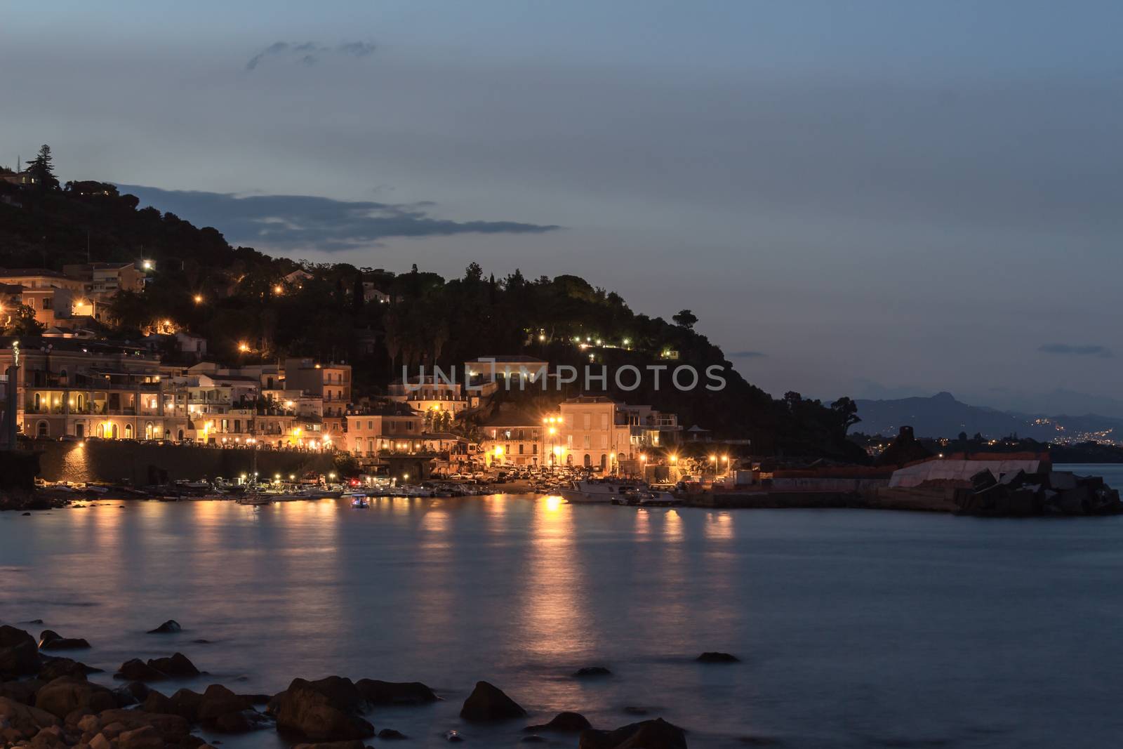 Waterfront street and old buildings by night.