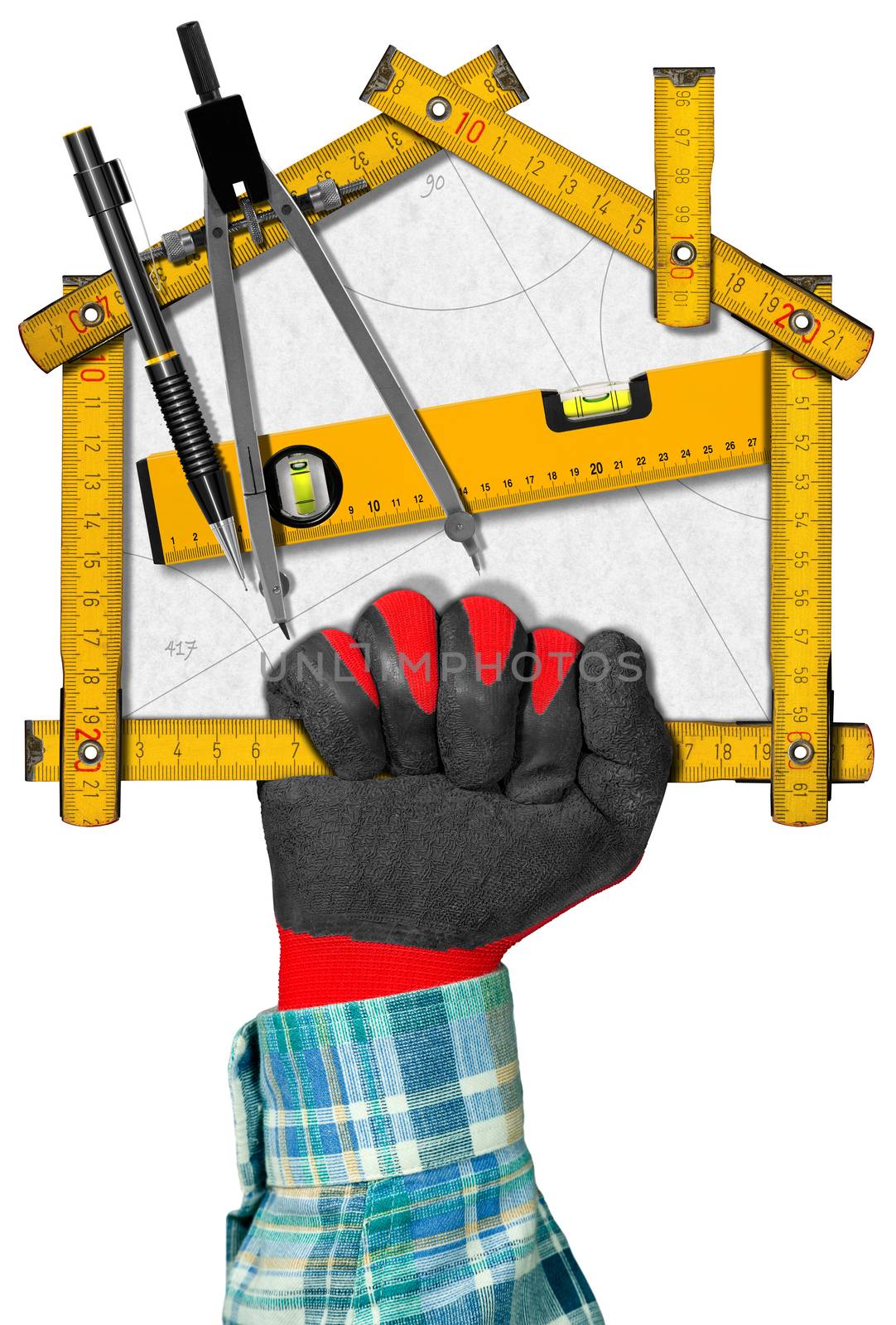 Hand holding a wooden meter ruler in the shape of house with a pencil, drawing compass and a spirit level on a white paper. Concept of house project
