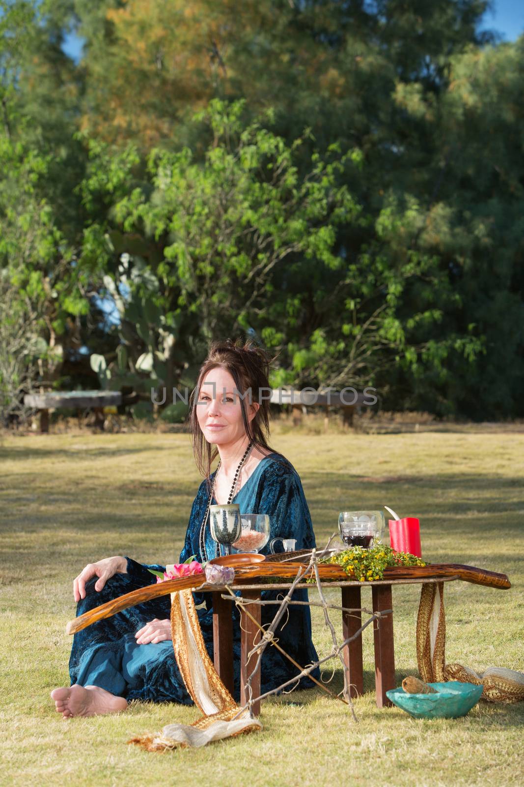 Beautiful polytheist woman in blue sitting outdoors