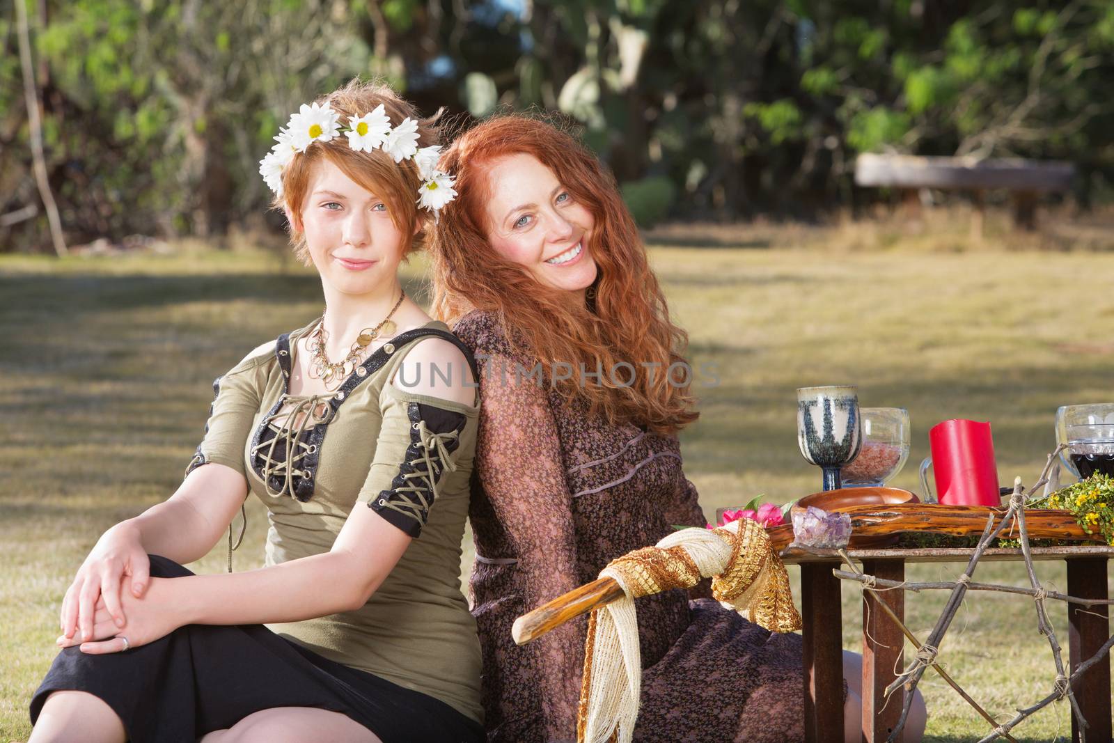 Pair of smiling women at outdoor pagan altar