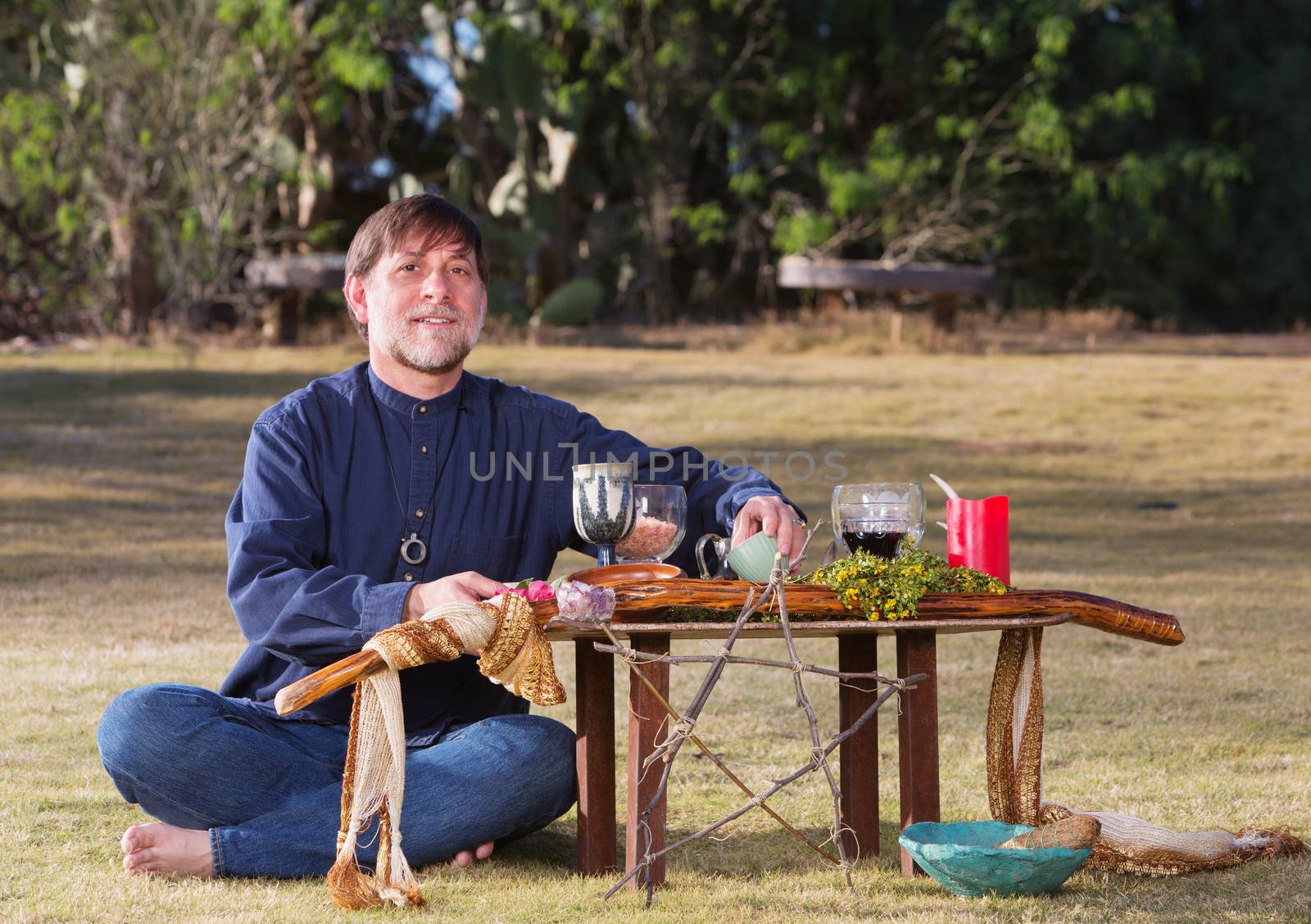 Single bare foot male at pagan altar outdoors