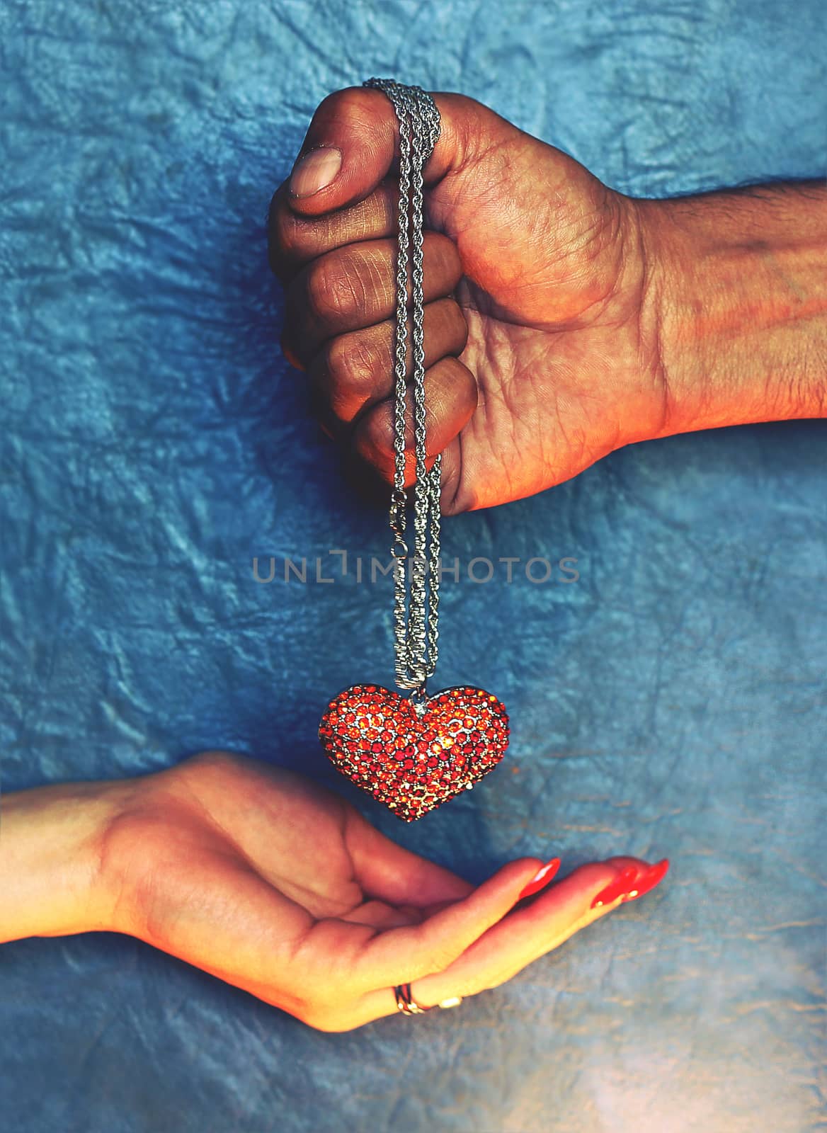 Necklace heart in the hands of men and women