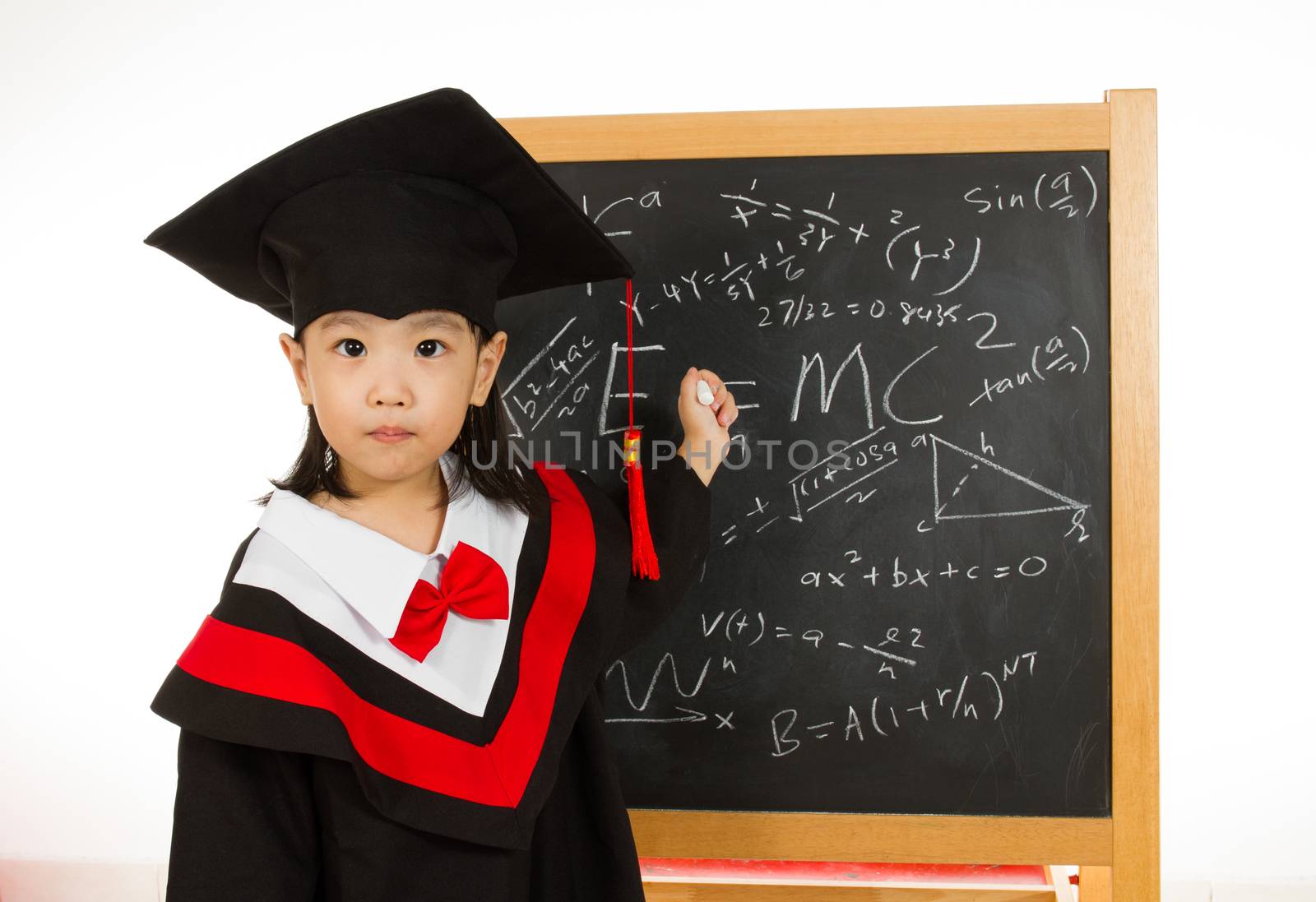 Asian Chinese children in graduation gown againts blackboard or chalkboard with formulas in plain isolated white background.