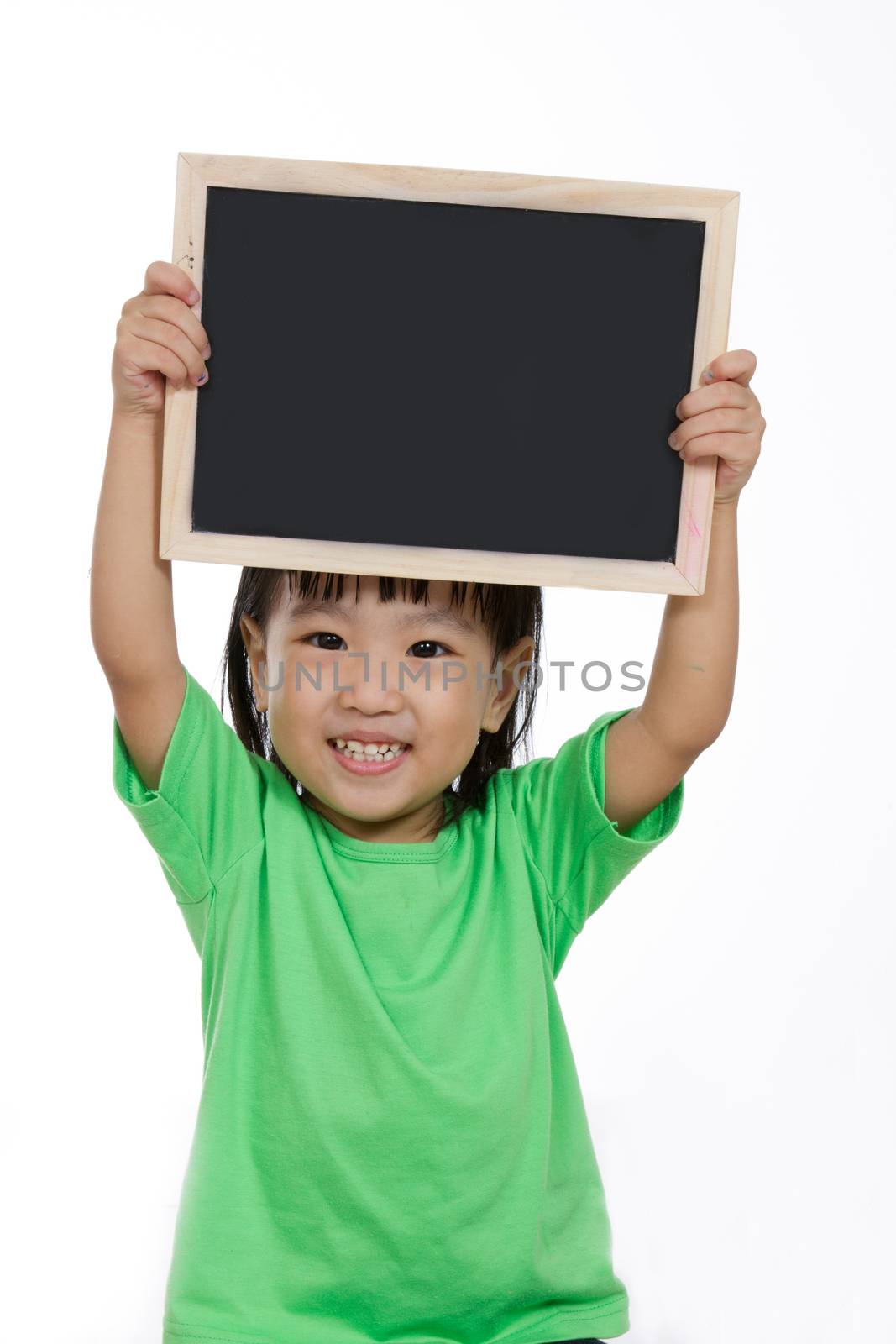 Asian Chinese children holding balckboard in plain isolated white background.