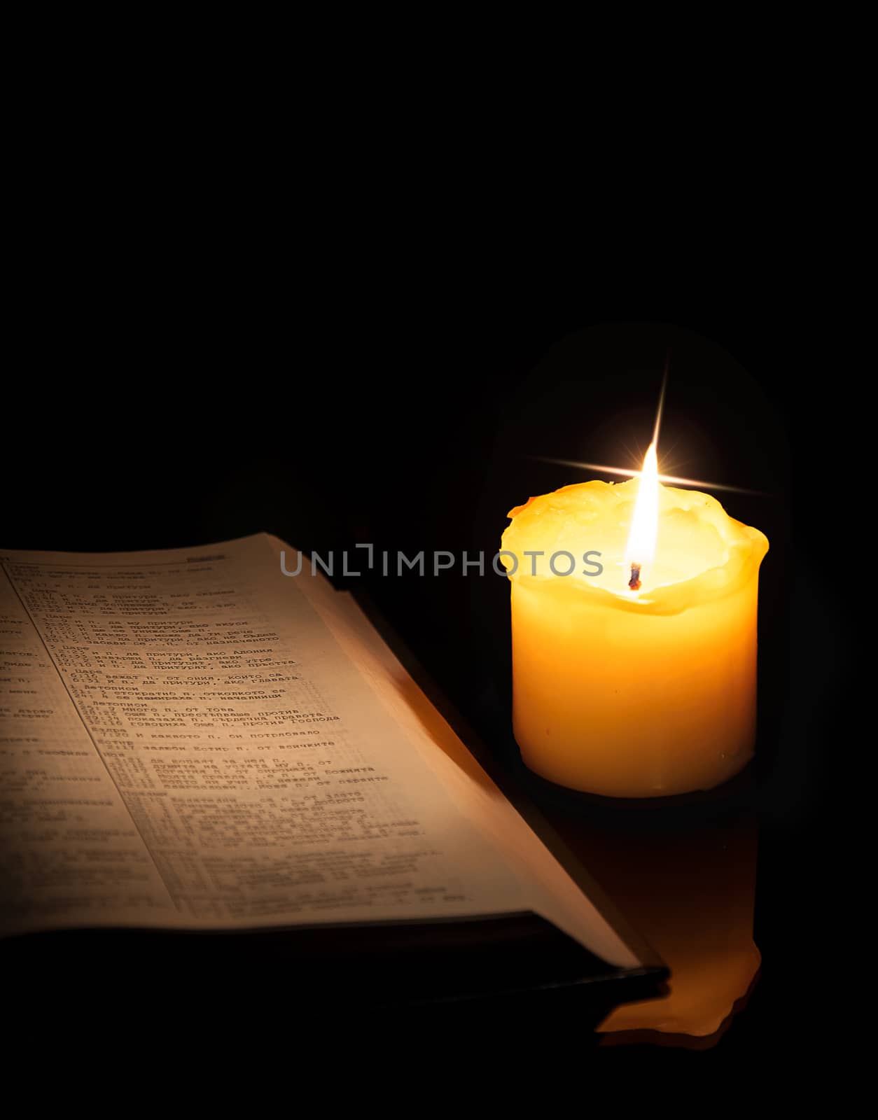 open book and burning candle