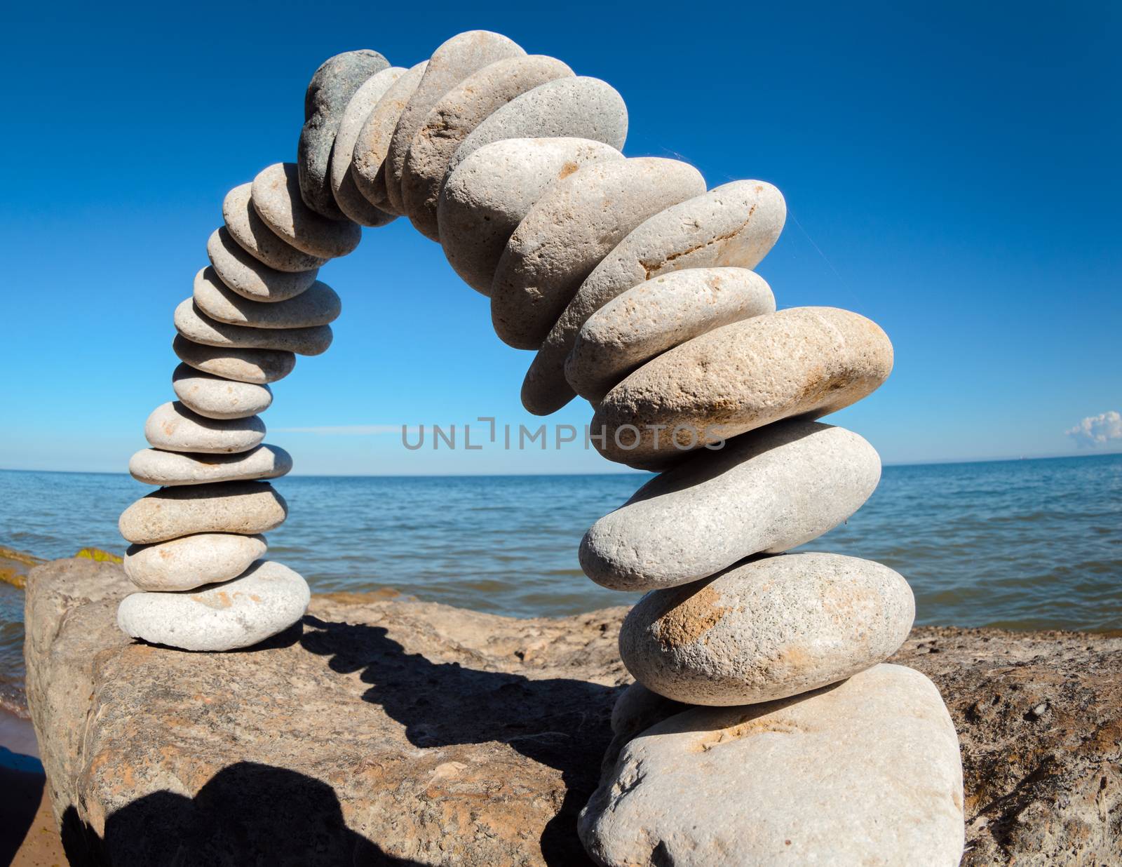 Pebbles laid out in the form of a arch on the stony coast