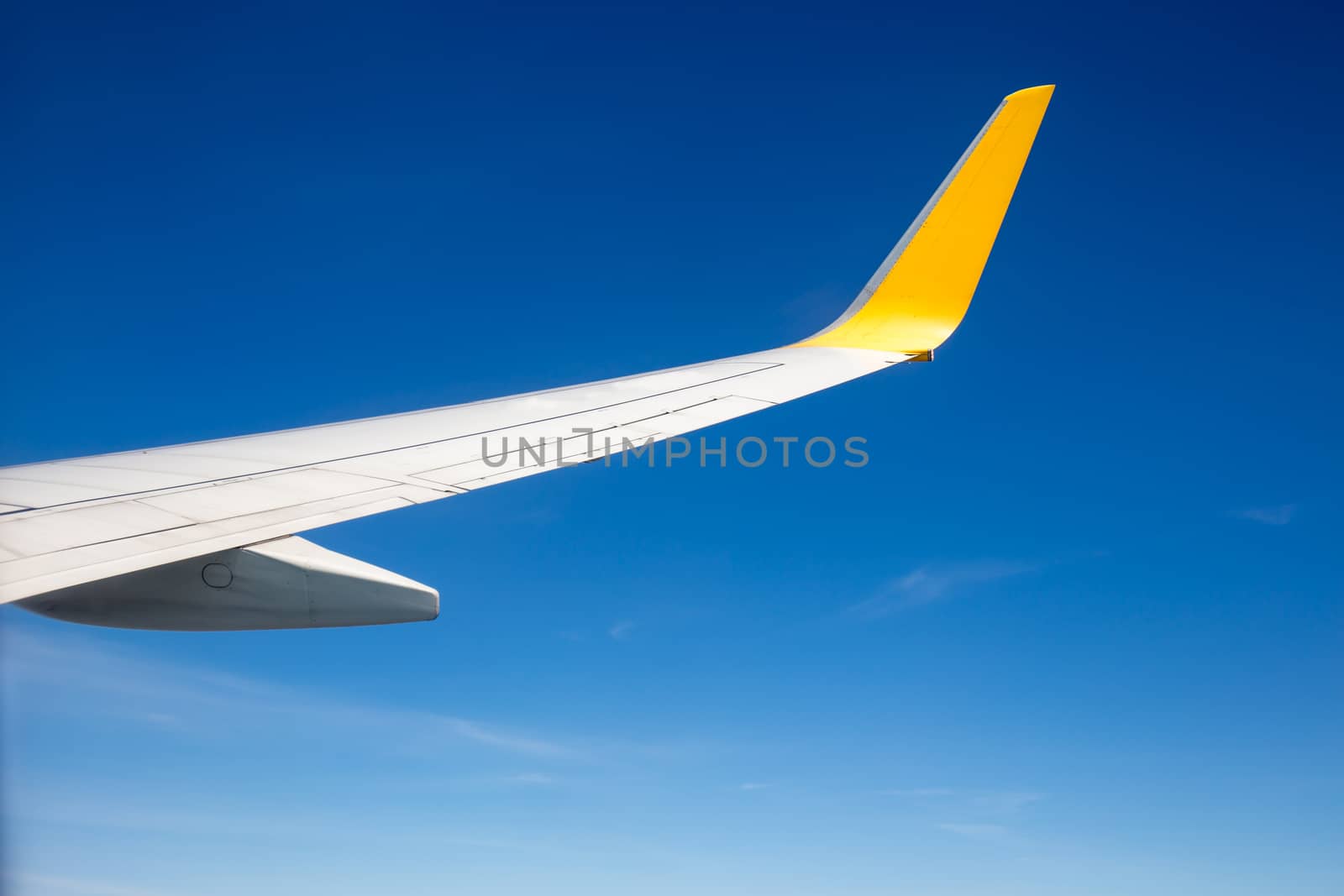 Wing of the plane with blue sky