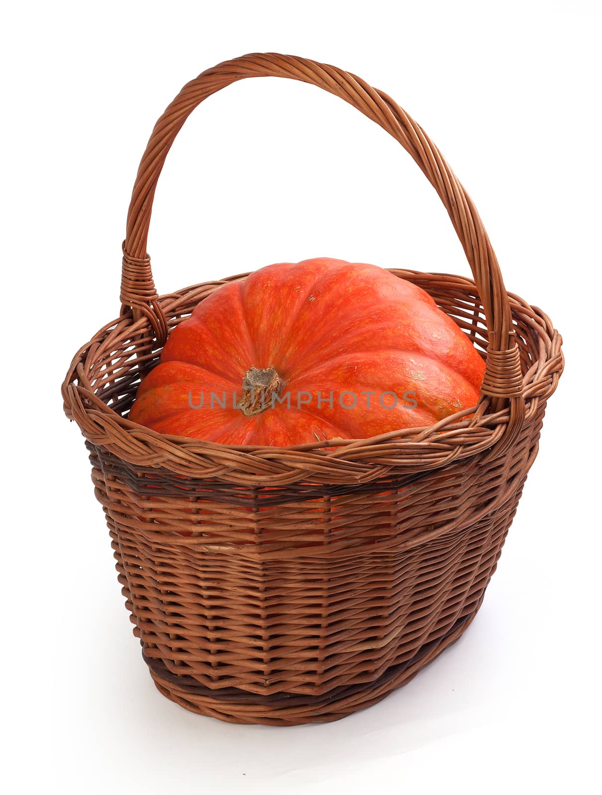 Fresh orange pumpkin in the brown basket