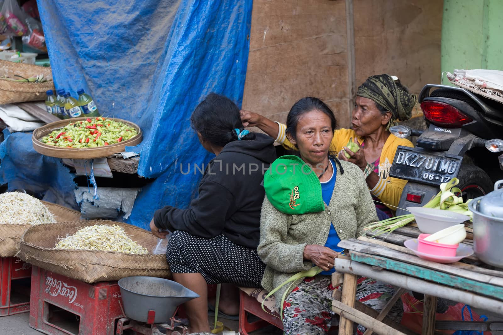 PENIDA ISLAND, INDONESIA - JUNE 30.2015: woman Hindu at the traditional daily street market, village Toyopakeh, Nusa Penida, Bali June 30. 2015 Indonesia