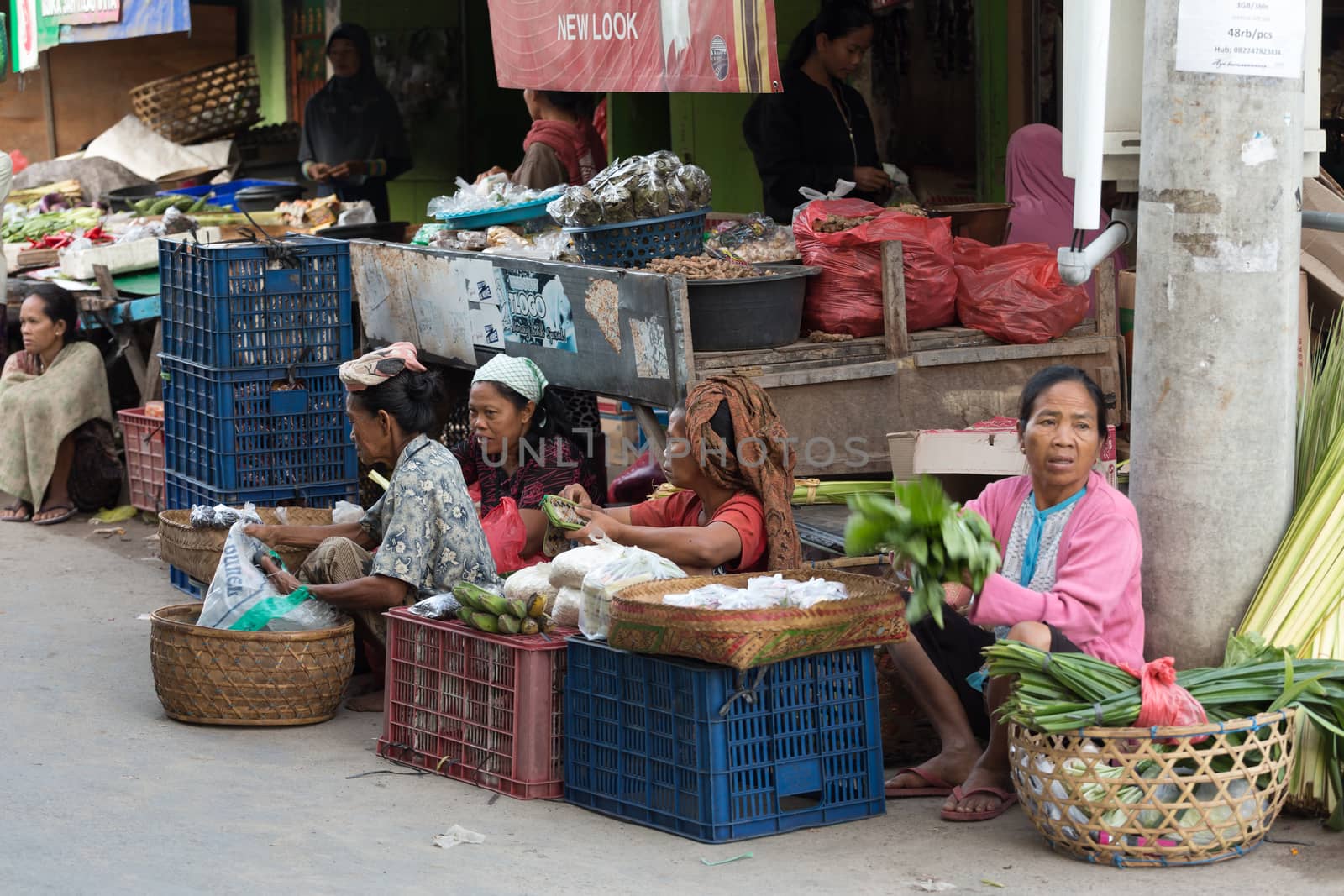 PENIDA ISLAND, INDONESIA - JUNE 30.2015: woman Hindu at the traditional daily street market, village Toyopakeh, Nusa Penida, Bali June 30. 2015 Indonesia