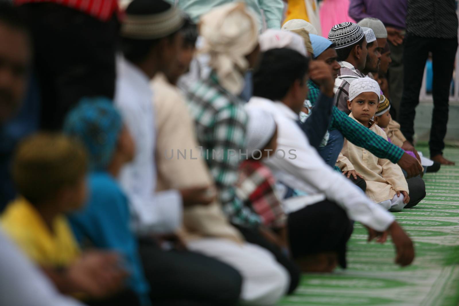 NEPAL, Kathmandu: A Muslim child sits with other worshippers in celebration of Eid-al-Adha by offering prayers at a Kasmere Jama mosque in Kathmandu in Nepal on September 25, 2015. The festival marks the end of Hajj, which is a holy pilgrimage that many Muslims make every year. People of Islamic faith have felt more comfortable celebrating Eid ul-Adha in Nepal after the country ushered in a new democratic, secularist constitution