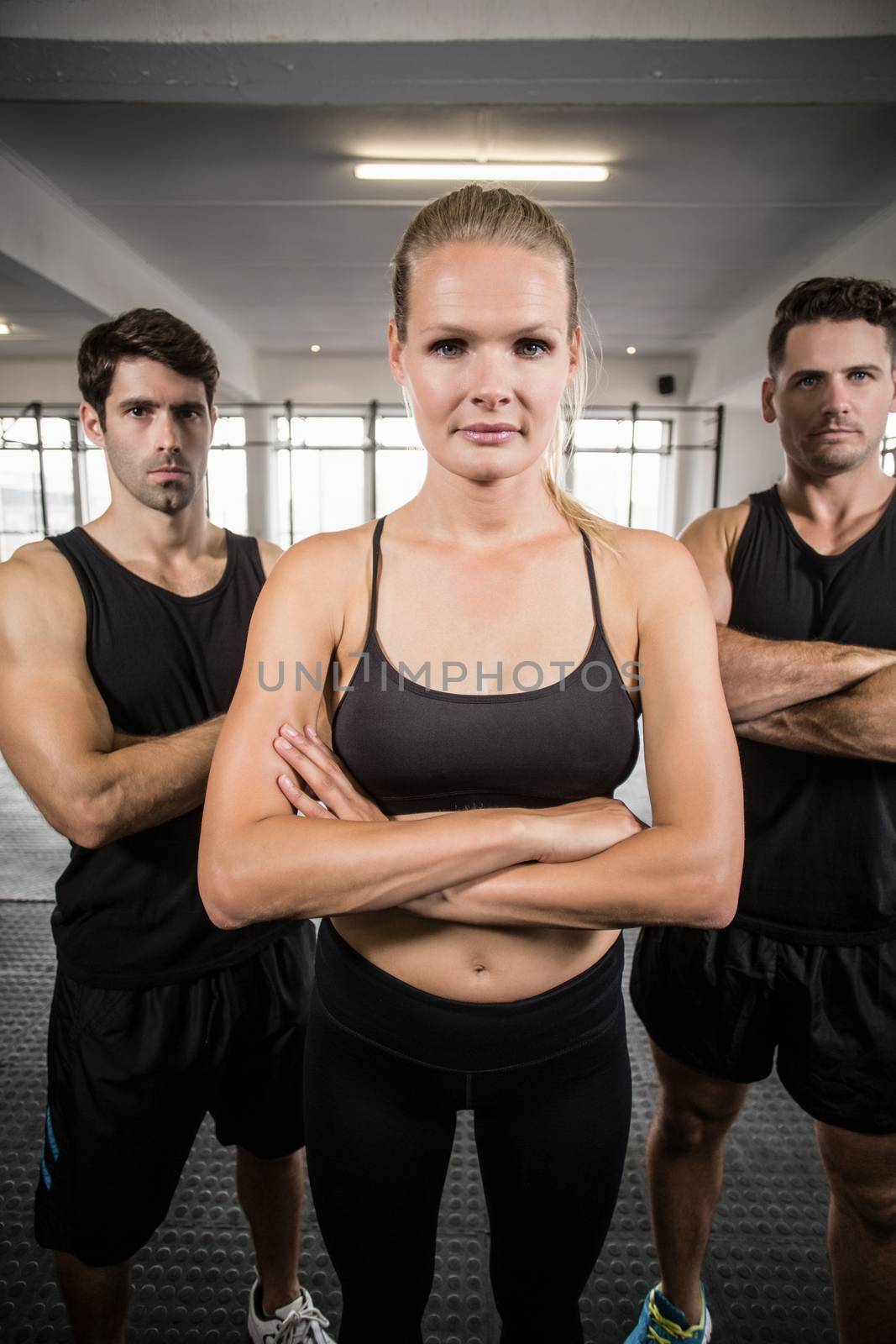 Fit people facing to the camera in crossfit gym