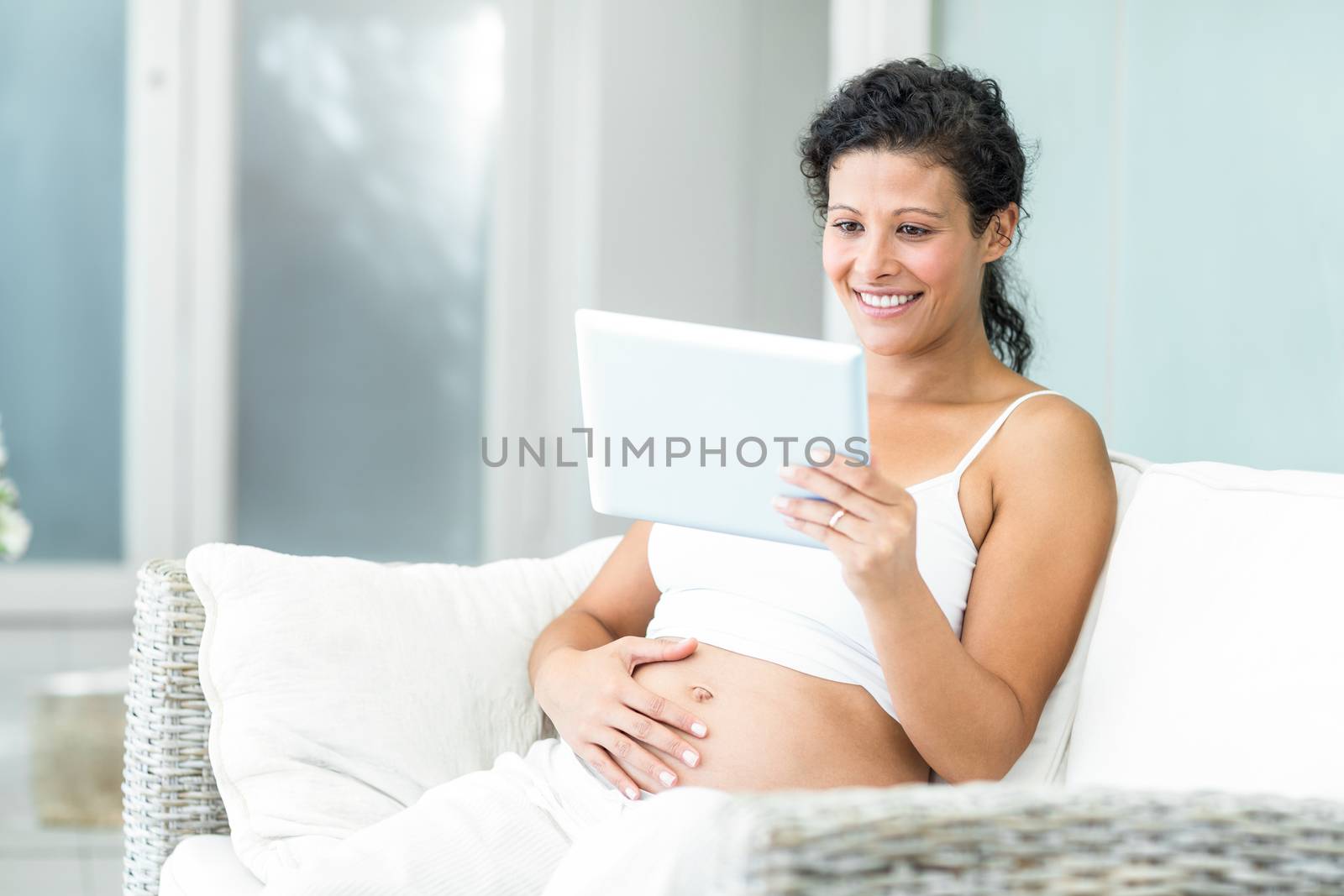 Happy woman video chatting on tablet by Wavebreakmedia
