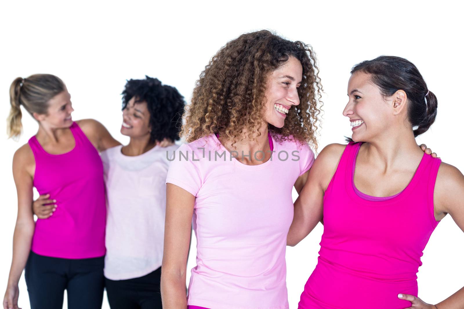 Happy women with arms around while standing against white background