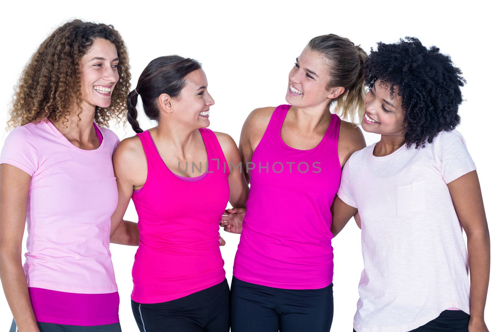 Smiling group of women with arms around while standing against white background