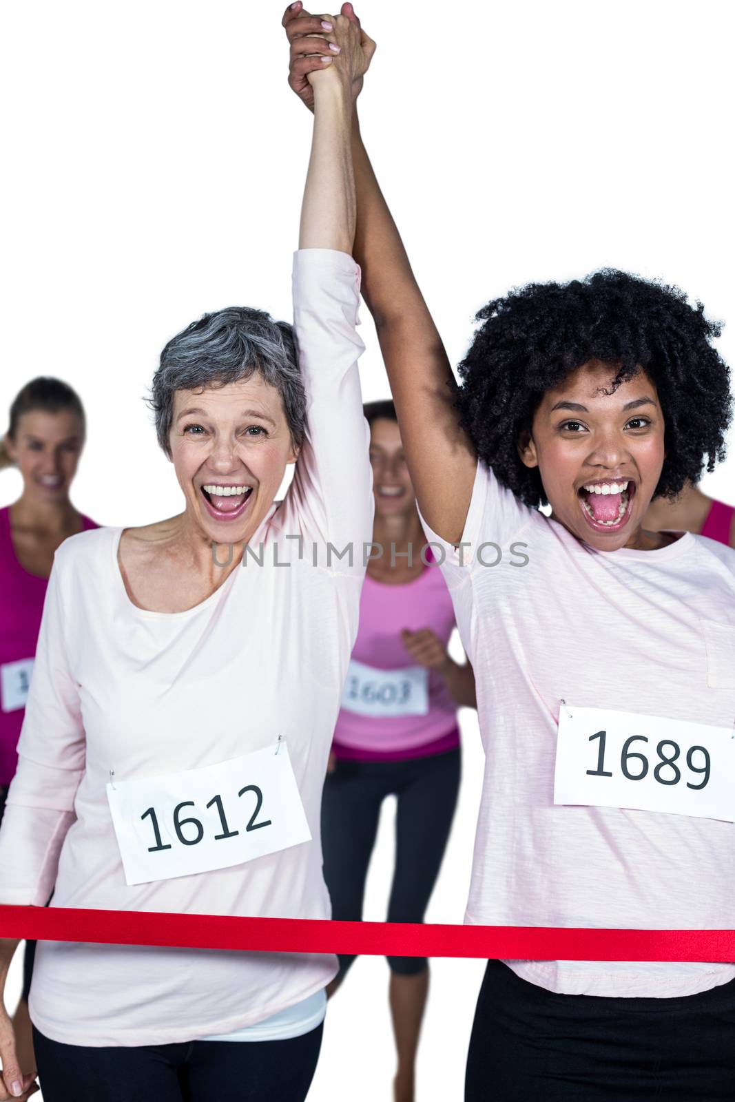 Portrait of smiling winner athletes crossing finish line with arms raised against white background