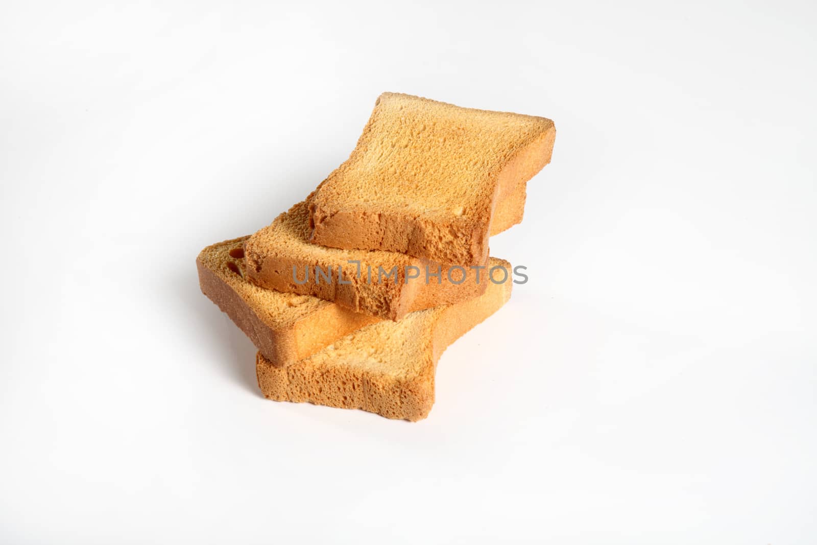 group of four slices toast on white  by diecidodici