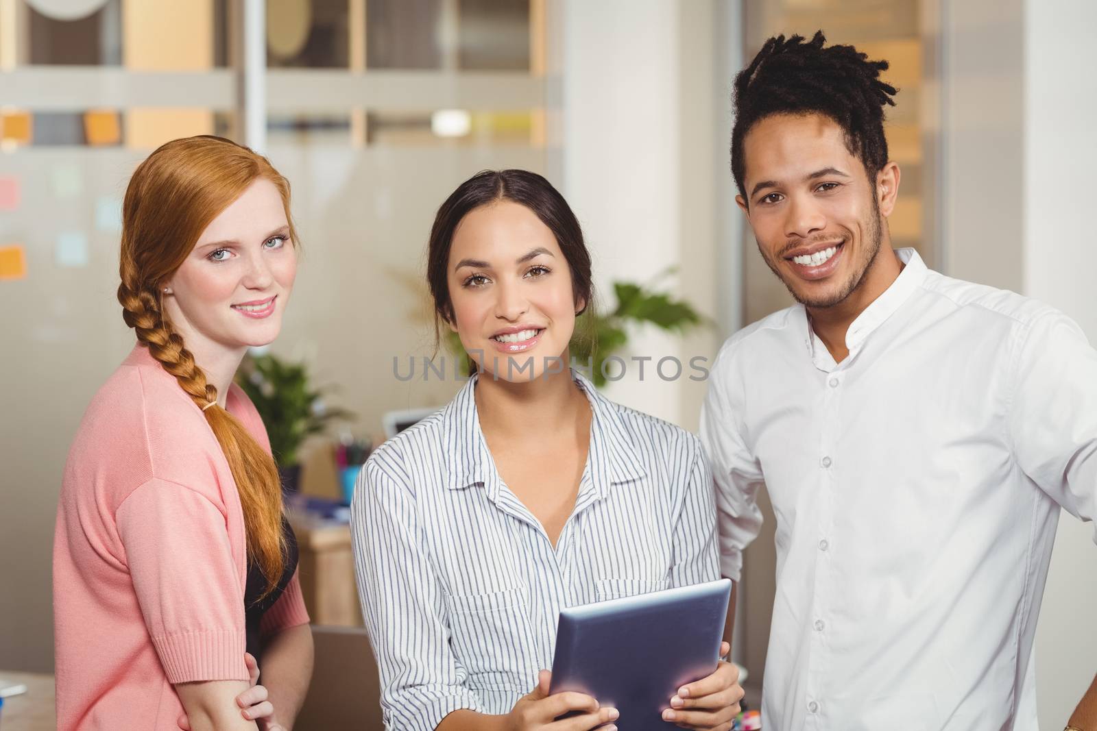 Portrait of confident business people smiling at office 