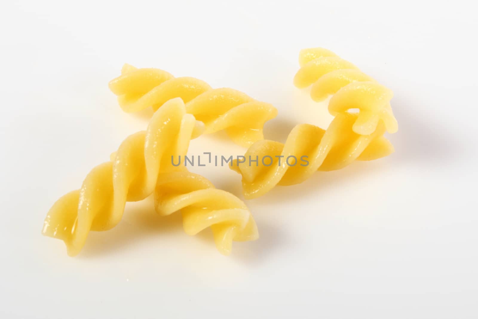 fusilli on white background