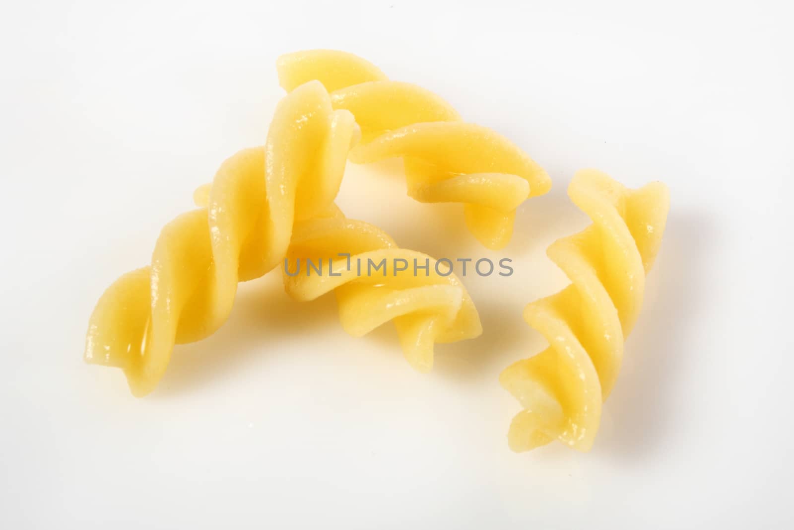 fusilli on white background