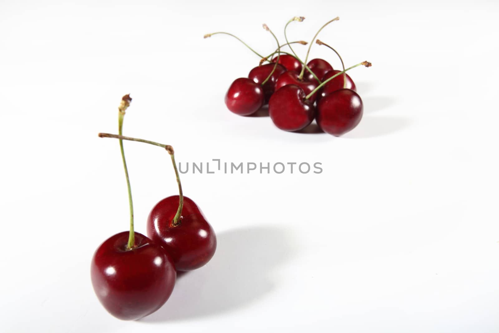 sweet cherries isolated on white by diecidodici