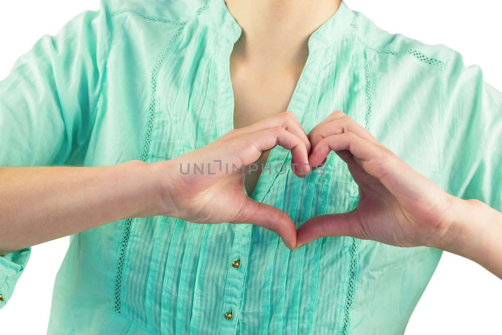 Mid section of woman making heart shape of fingers  by Wavebreakmedia